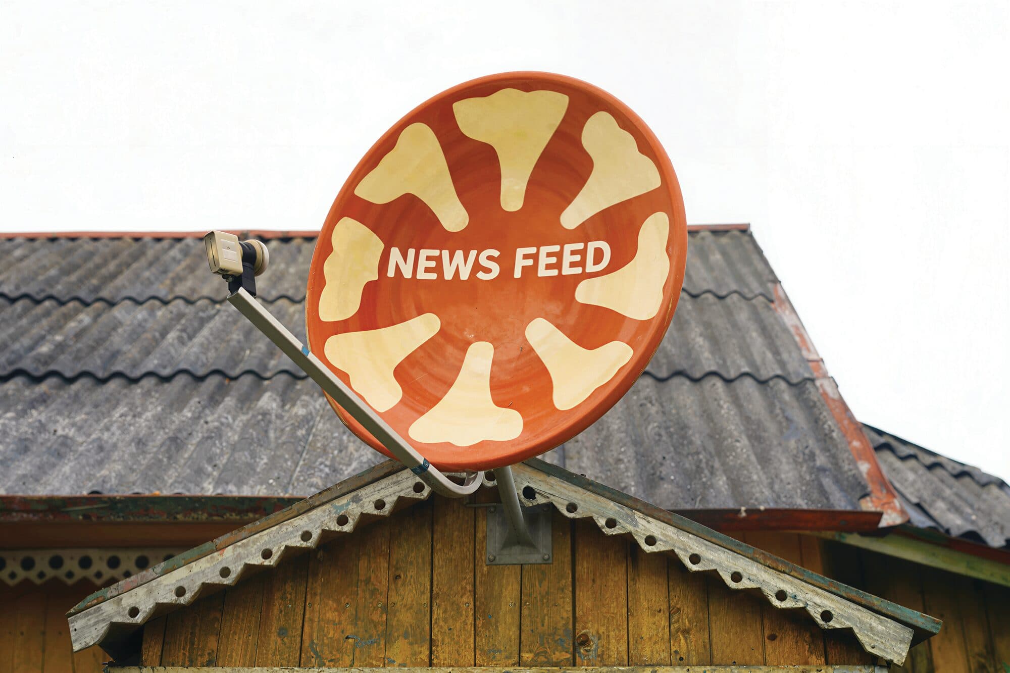 Satellite dish painted as a bowl of hummus, from the NEWS FEED spread